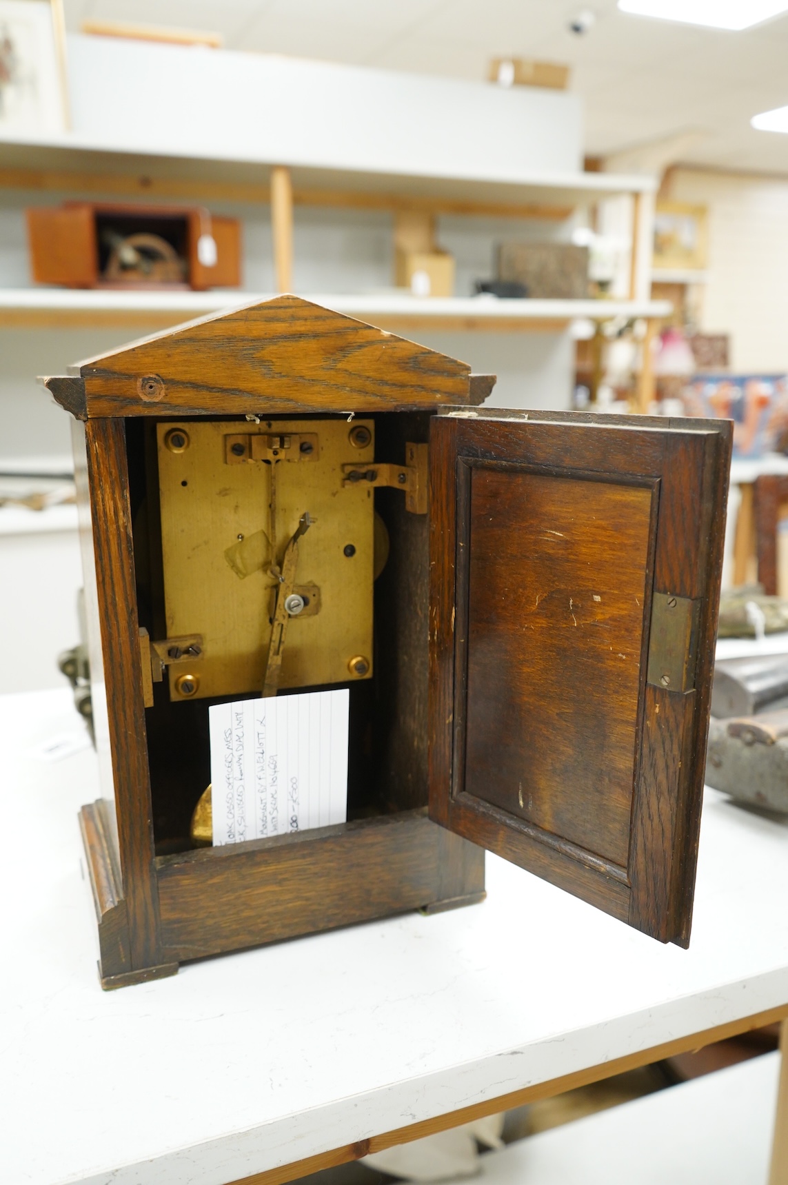 A RAF oak cased Officer's Mess mantel timepiece, with winding key, case key and pendulum, silvered dial engraved with crowned RAF surrounded by laurel insignia, and an 8 day fusee movement by F.W. Elliott, dated 1938, 35